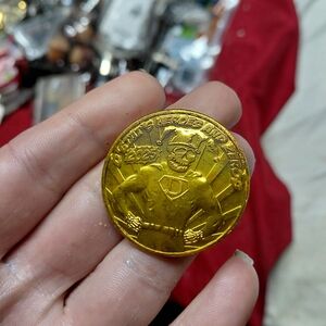 collectible 2025 metallic gold doubloon from the Krewe d'Etat Mardi Gras parade